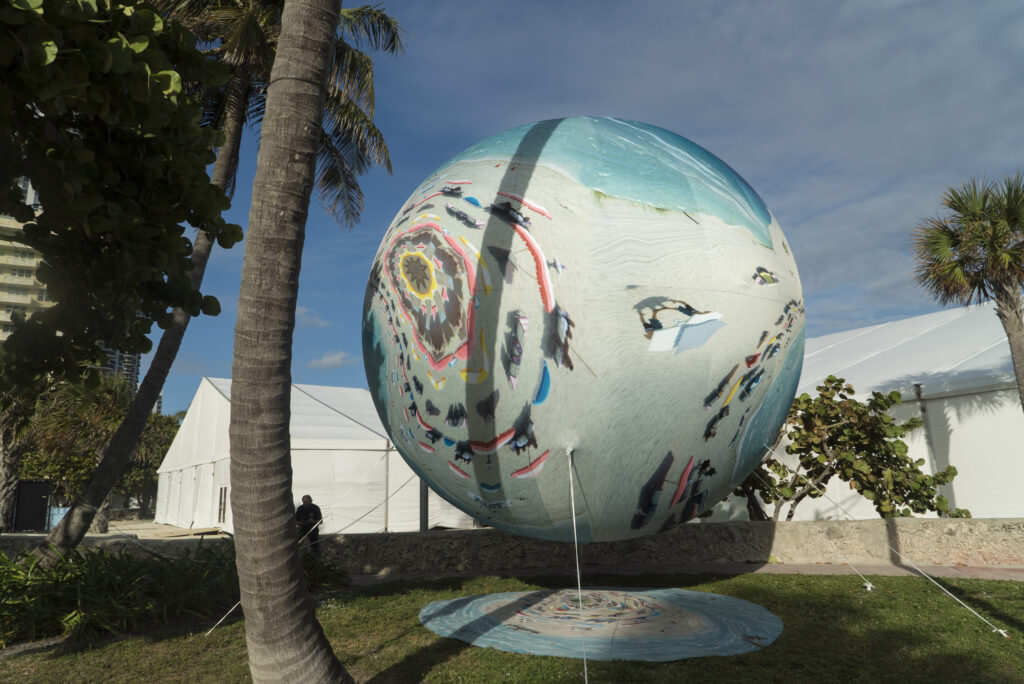 Adrift on Titan (Miami Marbles series) at PULSE Contemporary Art Fair Miami Beach, FL, 2016. The first PULSE PROJECTS Special Commission, Miami Marbles is a mixed augmented reality (AR) installation combining AR components, via a custom app, with nine physical helium-filled spheres—ranging from seven to 16 feet in diameter— printed with digitally manipulated footage of Miami Beach; Courtesy of Anne Spalter